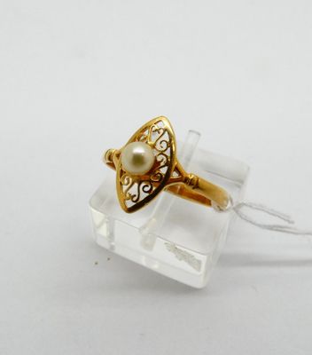 a close up of a gold ring with a pearl in it