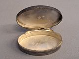a small silver box that is open on a table