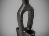 an image of a black vase with a handle on a table