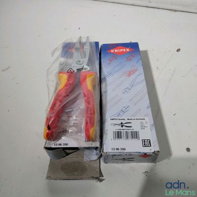 a pair of pliers sitting on a table next to a box