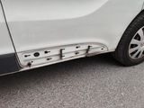 a close up of a white car with a dent in the side