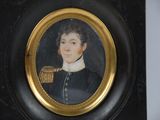 portrait of a young man in a black uniform in a gold frame
