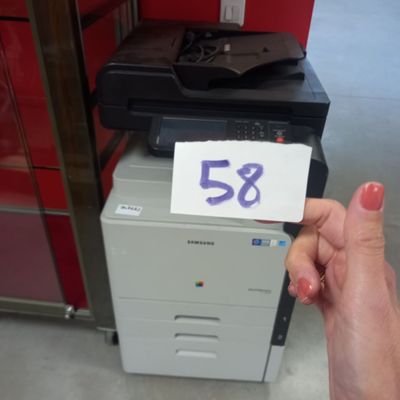 a person holding a piece of paper with the number 53 on it