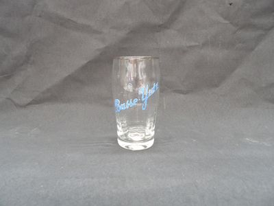 a glass with a blue writing on it on a gray background