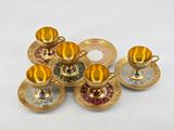 five cups and saucers sitting on a plate