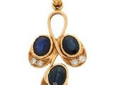an 18k gold pendant with sapphire and diamonds