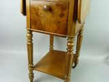 a small wooden table with a drawer on top of it