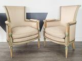 pair of upholstered armchairs in the style of louis xvi