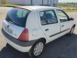 a small white car that is parked in a parking lot