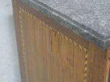 a close up of a wooden cabinet with a marble top