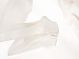 a pair of white shoes that are on a white surface