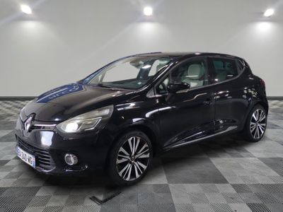 a black car parked on a checkered floor in a garage