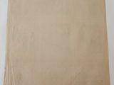 a brown paper bag sitting on top of a white table
