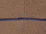 a close up of a piece of brown material with a blue line on it