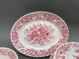 three plates and a bowl sitting on a table