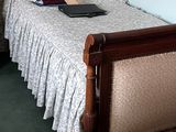 a bed with a wooden headboard and foot board in a room