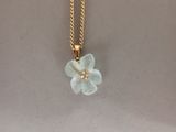 yellow gold chain with a flower pendant and a pearl bead
