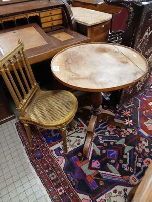 a table and two chairs in a room with a rug on the floor