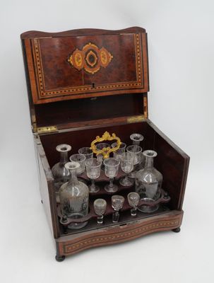 a wooden box with a set of wine glasses in it