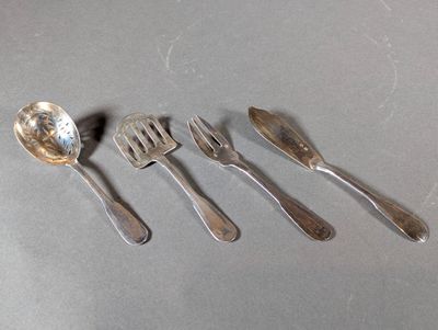 five spoons and a fork sitting on a table