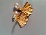 a close up of a brooch with pearls on it