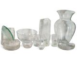 a lot of glass vases and bowls on the table