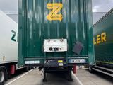 two semi trucks that are parked in a parking lot