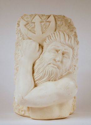 statue of a man holding a cross in his right hand