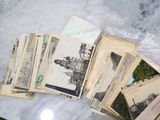 a lot of old postcards sitting on a marble table