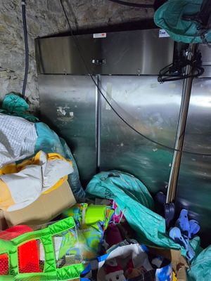 a pile of garbage in the corner of a room