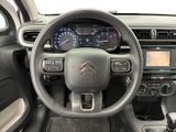 the interior of a car with a steering wheel and dashboard controls