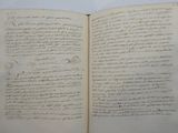 an open book with writing on it sitting on a table