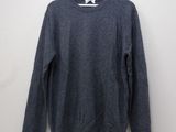 the sweater is hanging on a hanger on the wall