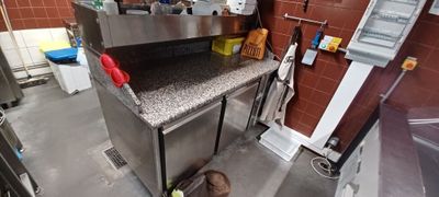 a little boy that is standing in front of a stove
