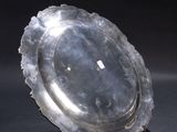 a silver plate sitting on top of a black table