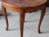 a small wooden table with a flower design on it