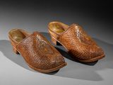 a pair of leather shoes with a woven design on the sole