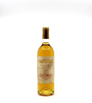 an image of a bottle of wine sitting on top of a white surface