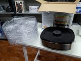 a table with a pan and a microwave on it