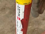 a red fire hydrant that has a yellow sticker on it
