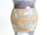 a vase that is sitting on a white surface