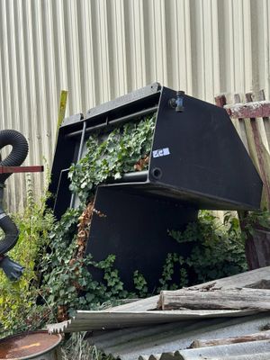 a pile of junk in front of a building with an elephant statue