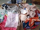 a box full of clothes and a fan in a room