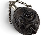 a black and white photo of a pocket watch on a chain