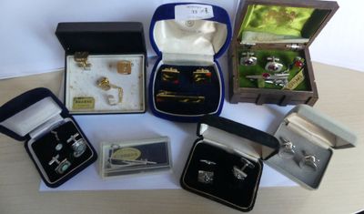 many different types of jewelry in boxes on a table
