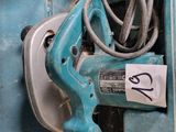 a blue machine that has a cord in it