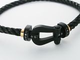 an image of a black leather bracelet with a black buckle