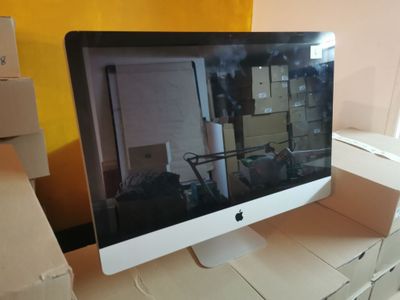 a computer monitor sitting on top of a desk