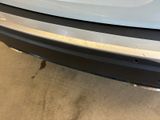 a close up of the rear end of a white car