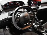 the interior of a car with a steering wheel and dashboard controls